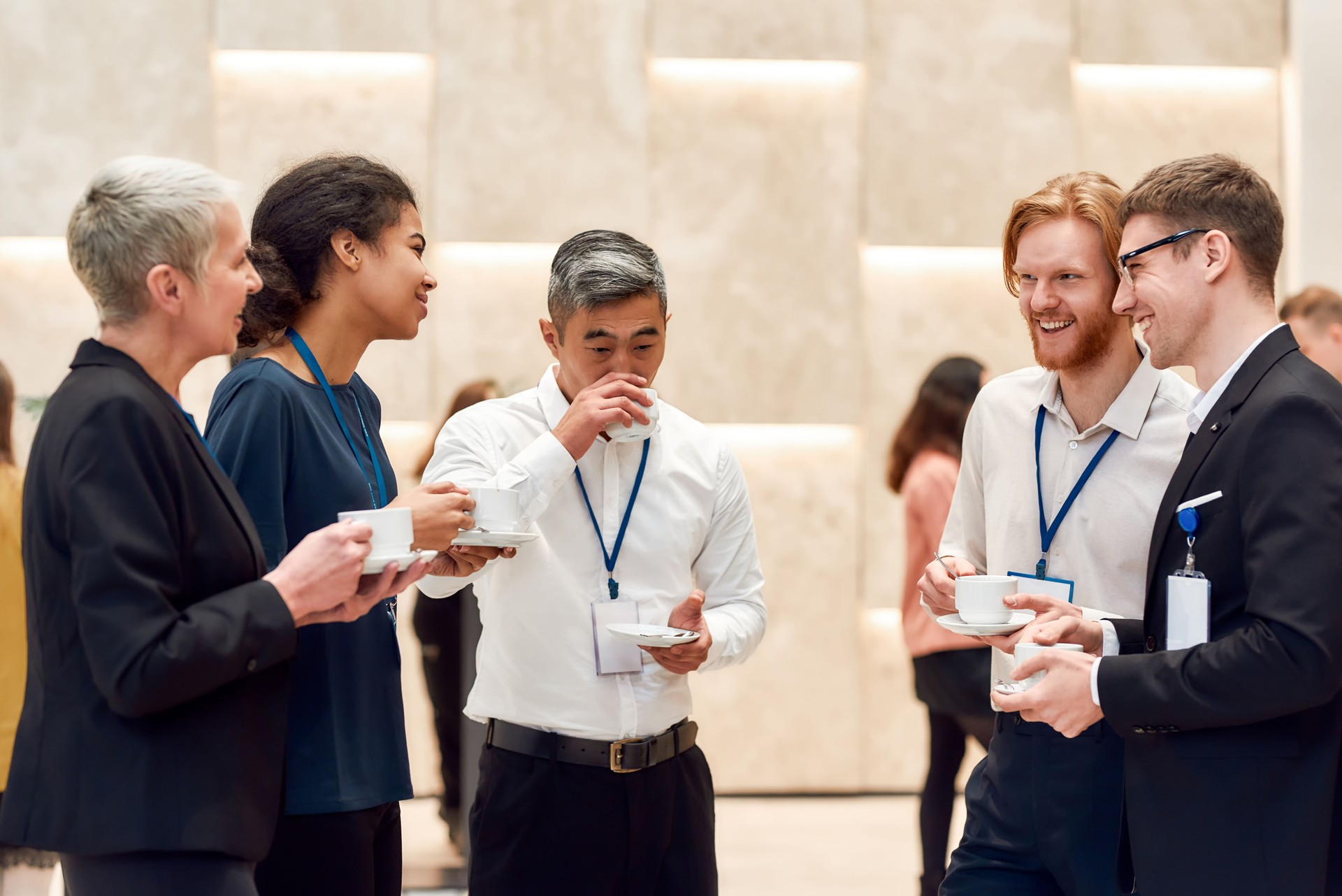 New Perspectives. Group of businesspeople talking while having coffee, tea during break at business meeting, forum